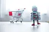 Online-Shopping concept: Toy robot and Miniature shopping cart